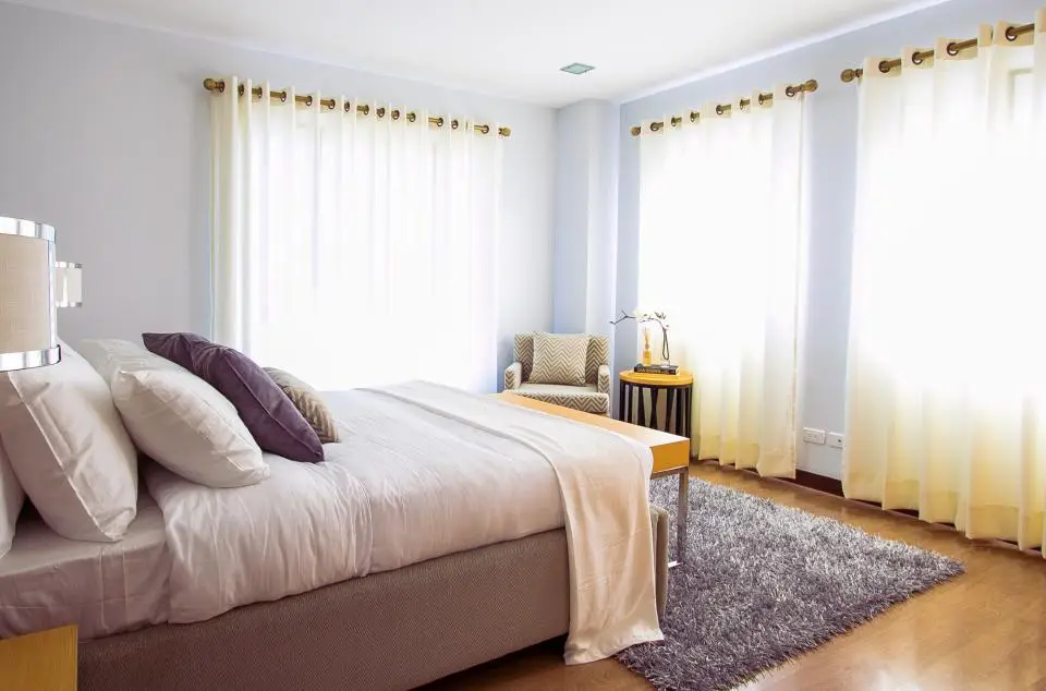 Bright bedroom with large windows (representative photo)